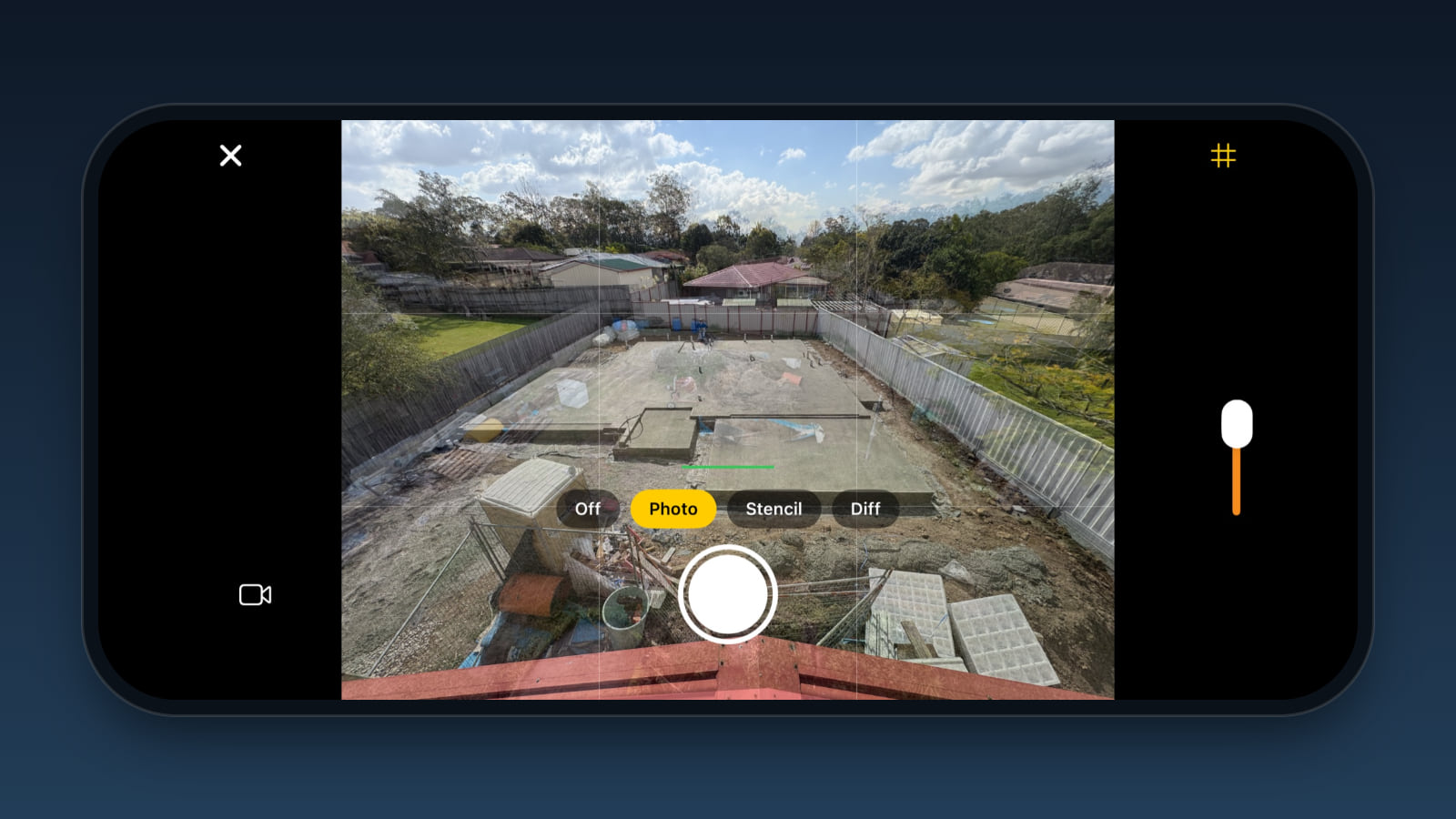 An iPhone held sideways, its camera as it looks in version 0.5.0: the 16 Aug key photo shows see-through over the 9 Sep concrete slab, with the grid on, the overlay at 35 per cent and Photo picked from the Off, Photo, Stencil and Diff buttons above the shutter