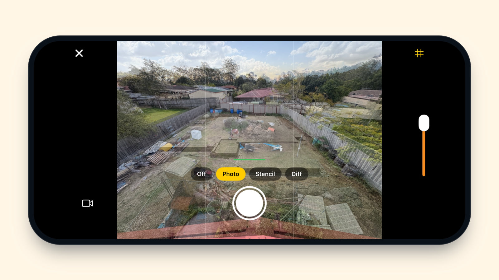 An iPhone held sideways, its camera in a landscape scene as it looks in versions 0.5.0 and 0.5.1: the 16 Aug key photo, with its mower, wheelbarrow and pallets, shows strongly over the view of a concrete slab, with the grid on, Photo picked from the Off, Photo, Stencil and Diff buttons, and the shutter ready